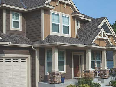 Two-story, mid-class home with light and dark brown siding